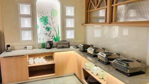 a kitchen with a stove and a counter top at Elegance Inn in Varanasi