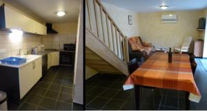 a kitchen and a living room with a staircase at Oustalou in Belcastel