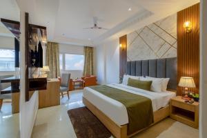 a hotel room with a bed and a desk at Arch The Venus - Free Airport Pickup or Drop in New Delhi +84 photos