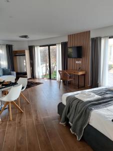 a hotel room with a bed and a dining room at Rafina Studio apartments kondilia in Rafina