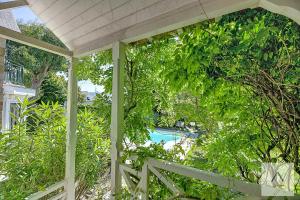 an outside view of a house with a fence and a pool at La Villa Moorings in Saint Malo