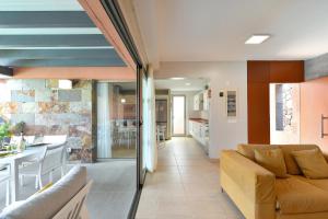 a living room with a couch and a kitchen at Yellow Sunshine 8 by VillaGranCanaria in Salobre