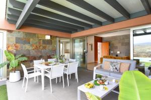 a living room with a table and chairs and a couch at Yellow Sunshine 8 by VillaGranCanaria in Salobre
