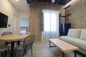 a living room with a couch and a table at Escolástica Suites Centro in Granada