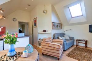 a living room with a couch and a table at Finest Retreats - Canal Central in Ball