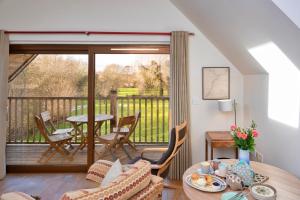 a living room with a table and a balcony at Finest Retreats - Canal Central in Ball