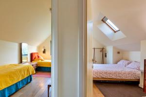 a bedroom with two beds and a skylight at Finest Retreats - Canal Central in Ball