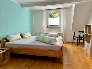 a bedroom with a bed with pillows on it at Ferienhaus Südpfälzer Wald in Spirkelbach