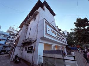 a white building with a sign on the side of it at Hotel Silver Leaf - Vile Parle East - Near Mumbai Airport in Mumbai