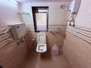 a small bathroom with a toilet and a window at Hotel Silver Leaf - Vile Parle East - Near Mumbai Airport in Mumbai +40 photos