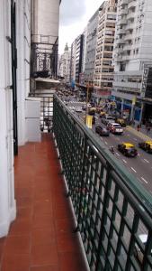 a balcony with a view of a busy city street at Corrientes y Uruguay in Buenos Aires