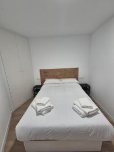 a white bed with two white towels on it at Vibre Canaris - Las Americas in Playa de las Americas +56 photos