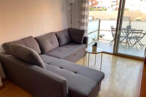 a living room with a gray couch and a table at NEW! Amazing 2 bedroom apartment in Rambla del Poblenou in Barcelona