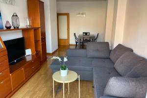 a living room with a couch and a table at NEW! Amazing 2 bedroom apartment in Rambla del Poblenou in Barcelona