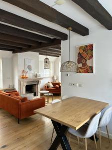 a living room with a wooden table and a couch at Urker Ussien in Urk