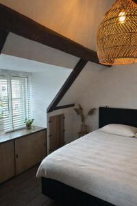 a bedroom with a large bed and a window at Urker Ussien in Urk