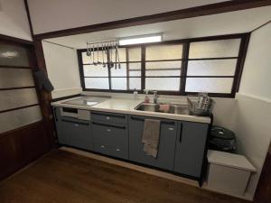 a kitchen with a sink and a counter top at 民泊 Knock Knock in Habikino