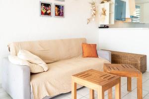 a living room with a couch and a table at Appartement Coconut in Saint-François