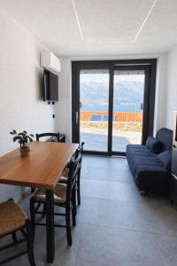 a living room with a table and a couch at Spigolo Nord in Bellano