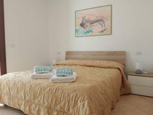a bedroom with a bed with two pillows on it at La Terrazza In Centro Dorgali in Dorgali