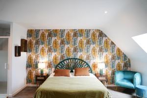 a bedroom with a green bed with a wall at Jungle Room - Studio avec spa privé in Quéven