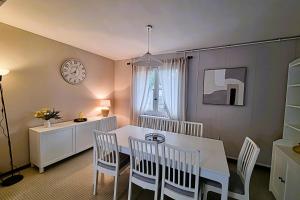 a dining room with a white table and chairs at Large family house 300m from the beach in Arcachon
