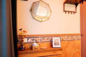 a mirror on the wall above a wooden shelf at Acogedor Apartamento Loft in Fuenlabrada