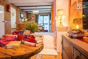 a pile of books sitting on a table in a room at Acogedor Apartamento Loft in Fuenlabrada