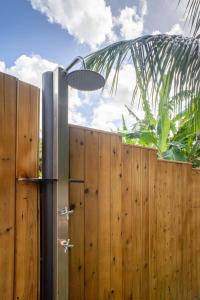a wooden fence with a light on top of it at Villa Kaz a Ramon in Port-Louis