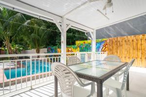 a patio with a table and chairs next to a pool at Villa Kaz a Ramon in Port-Louis +22 photos