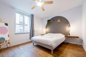 a bedroom with a bed and a ceiling fan at The workshop in Metz