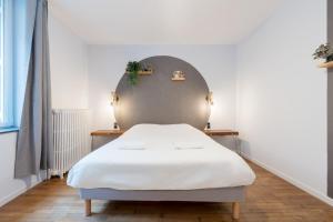 a bed in a room with a white mattress at The workshop in Metz +9 photos