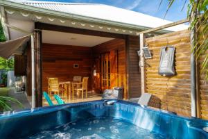 a house with a swimming pool in front of it at Bungalow Kaz Graj in Sainte-Anne