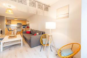 a living room with a couch and chairs and a table at 2 Rue du Parc in Annecy +9 photos