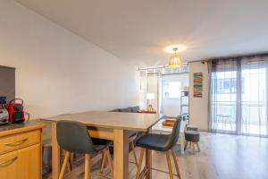 a dining room with a wooden table and chairs at 2 Rue du Parc in Annecy