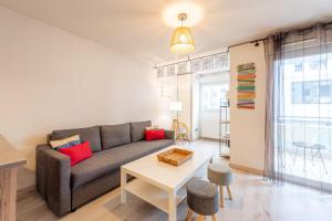 a living room with a couch and a table at 2 Rue du Parc in Annecy