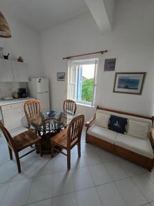 a living room with a table and a couch at Kapsali Beach House in Kapsali +8 photos