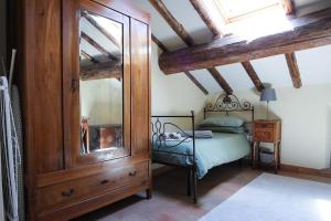a bedroom with a bed and a dresser and a mirror at Guest House Dell'Affresco in Reggio Emilia