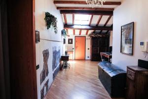 a living room with a couch and a wooden floor at Guest House Dell'Affresco in Reggio Emilia