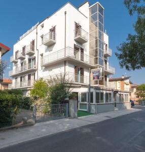 a white building on the side of a street at Regina Hotel e Ristorante in Punta Marina