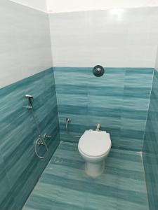 a bathroom with a toilet and a shower at Pushpanjli grand inn in Ayodhya