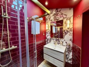 a red bathroom with a sink and a shower at Hylton House in Birmingham +6 photos