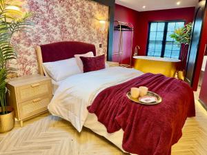 a bedroom with a bed with a plate of food on it at Hylton House in Birmingham