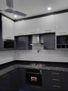 a kitchen with a black and white stove top oven at Mya Apartment in Madina