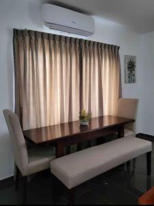 a dining room table with two chairs and aention at Mya Apartment in Madina