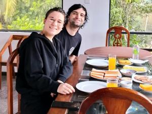 a man and woman sitting at a table with food at Mountain Breeze Villa & Ayurveda Spa in Ella