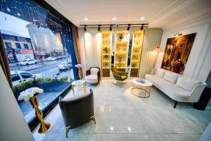 a living room with a couch and chairs and a window at İSTPORT GARDEN HOTELS in Arnavutköy