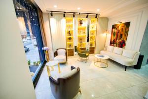 a living room with a couch and chairs and tables at İSTPORT GARDEN HOTELS in Arnavutköy