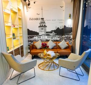 a living room with a couch and two chairs at İSTPORT GARDEN HOTELS in Arnavutköy
