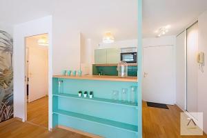 a bathroom with a blue shelf in a room at Le Prieuré in Dinard +2 photos